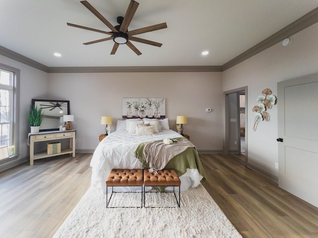 bedroom featuring crown molding, hardwood / wood-style floors, and ceiling fan