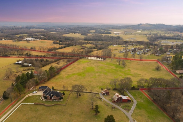 aerial view at dusk featuring a rural view