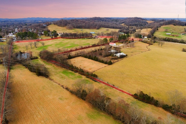 aerial view at dusk featuring a rural view
