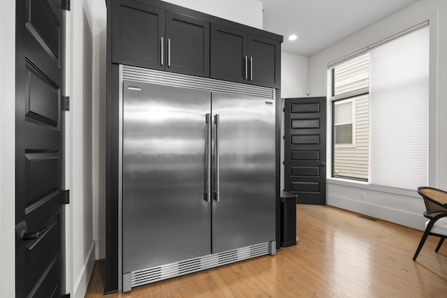 kitchen with light hardwood / wood-style floors and stainless steel built in fridge