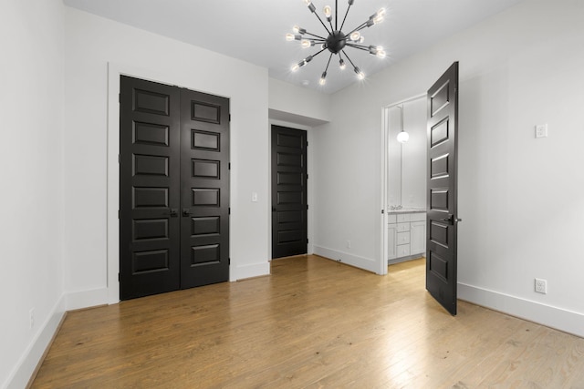 foyer entrance with a chandelier and light hardwood / wood-style floors