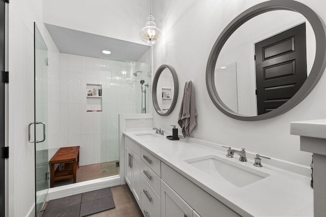 bathroom with a shower with door and vanity