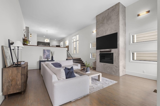 living room featuring a fireplace and wood-type flooring