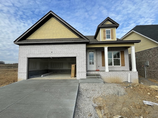 view of front facade with a garage and covered porch