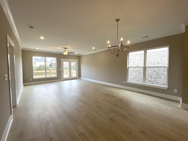 empty room featuring baseboards, wood finished floors, crown molding, french doors, and recessed lighting