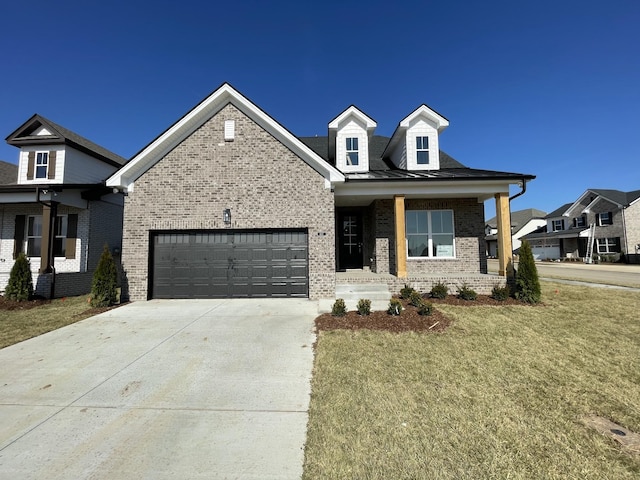 view of front facade with an attached garage, driveway, a front lawn, and brick siding