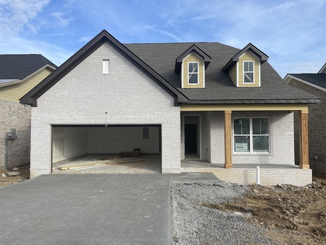 view of front facade with a porch and a garage