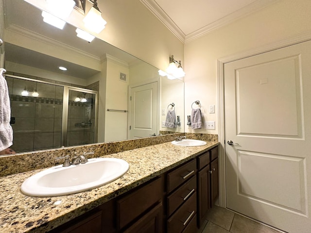 bathroom with vanity, tile patterned flooring, crown molding, and an enclosed shower