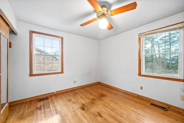 unfurnished bedroom featuring ceiling fan, a closet, and light wood-type flooring