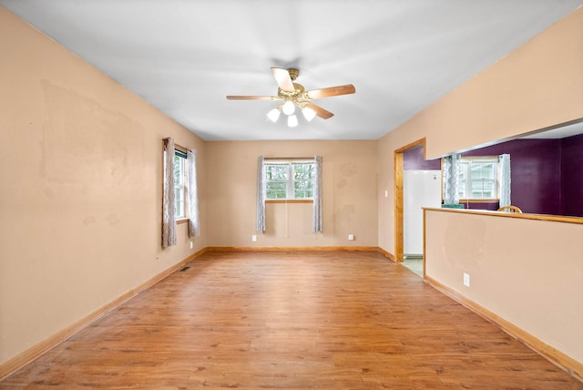 unfurnished room featuring ceiling fan and light wood-type flooring