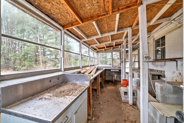 unfurnished sunroom with lofted ceiling and a healthy amount of sunlight