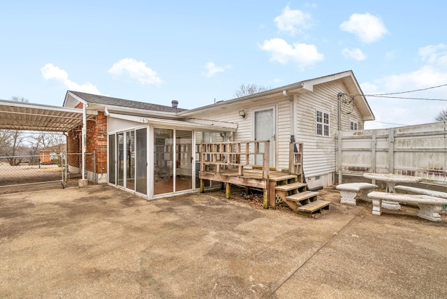 rear view of property with a patio and a sunroom