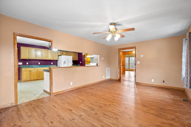 unfurnished living room featuring light hardwood / wood-style flooring and ceiling fan