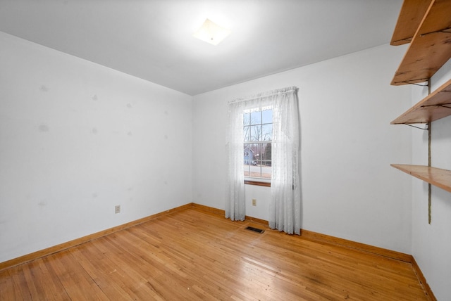 empty room with light hardwood / wood-style flooring