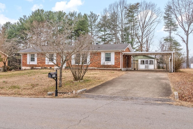 ranch-style house with a front lawn and a carport