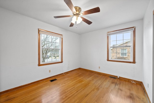 empty room with light hardwood / wood-style floors and ceiling fan