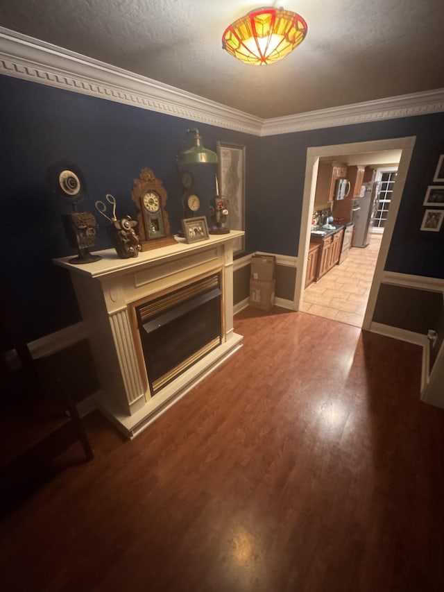 living room featuring crown molding and wood-type flooring