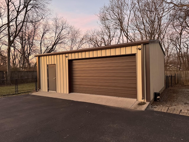 view of garage at dusk