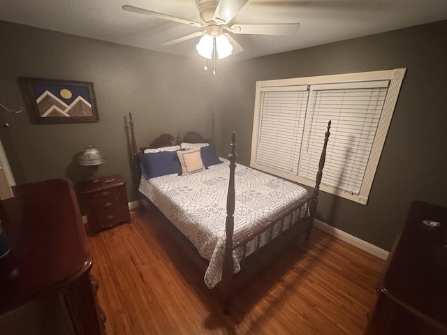 bedroom featuring dark hardwood / wood-style floors and ceiling fan