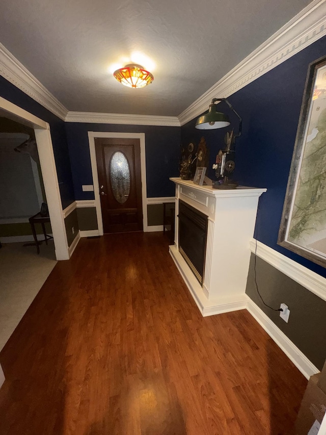 foyer with dark hardwood / wood-style flooring and crown molding