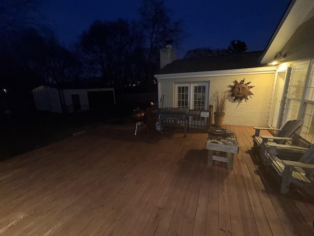 deck at night with area for grilling