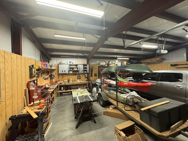 garage with a garage door opener and a workshop area