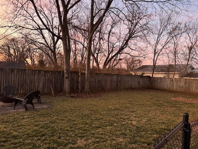 yard at dusk featuring a patio area