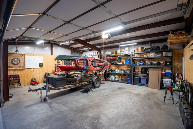 garage with wooden walls and a garage door opener