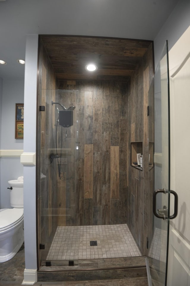 full bathroom with a stall shower, toilet, and recessed lighting