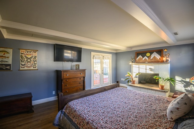 bedroom featuring beam ceiling, crown molding, visible vents, wood finished floors, and baseboards