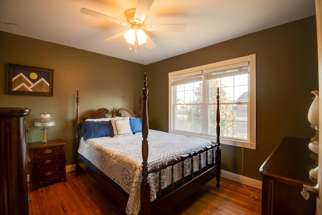 bedroom featuring a ceiling fan, baseboards, and wood finished floors