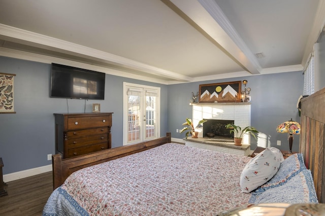 bedroom featuring wood finished floors, baseboards, ornamental molding, a brick fireplace, and beam ceiling