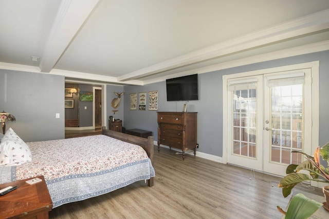 bedroom with baseboards, ornamental molding, wood finished floors, access to exterior, and french doors