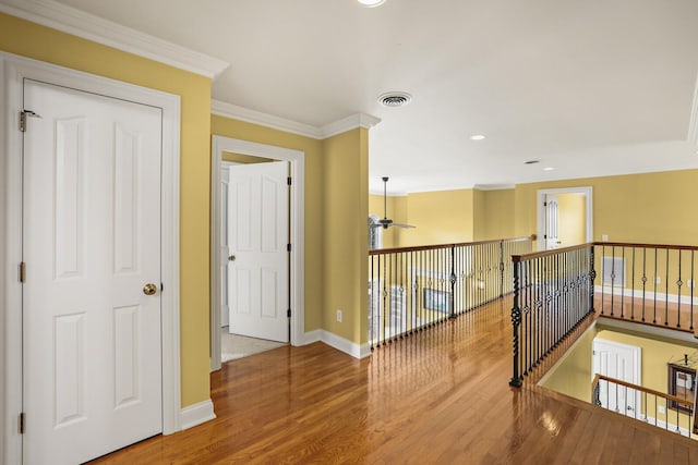 hallway featuring hardwood / wood-style flooring and ornamental molding