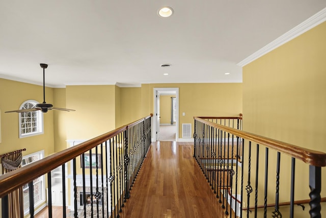 hallway with dark wood-type flooring and ornamental molding