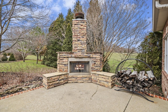 view of patio featuring an outdoor stone fireplace