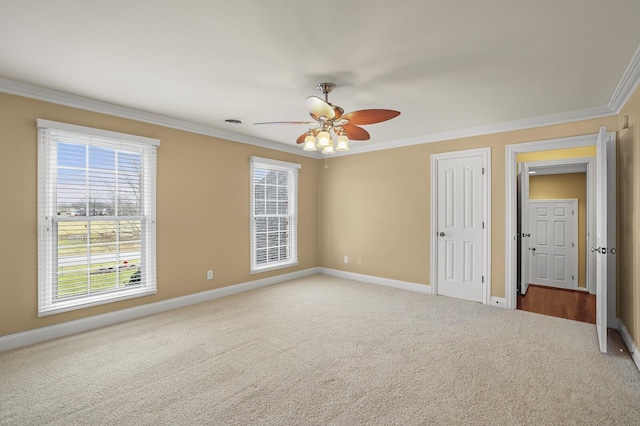 unfurnished bedroom with crown molding, ceiling fan, and carpet