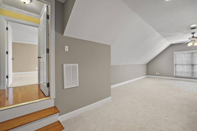 bonus room with lofted ceiling, light colored carpet, and ceiling fan