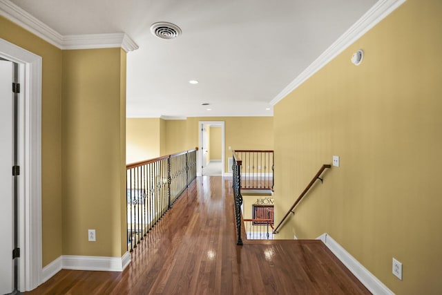 hallway featuring wood-type flooring and crown molding