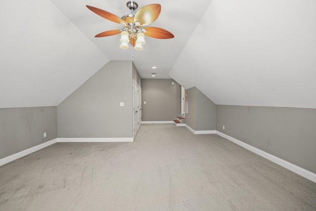 additional living space featuring ceiling fan, lofted ceiling, and light carpet