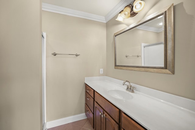 bathroom with tile patterned flooring, ornamental molding, and vanity