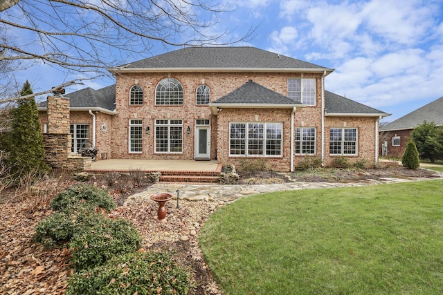 back of property featuring a yard and a patio