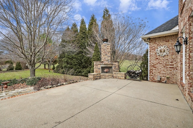 view of patio / terrace featuring an outdoor stone fireplace