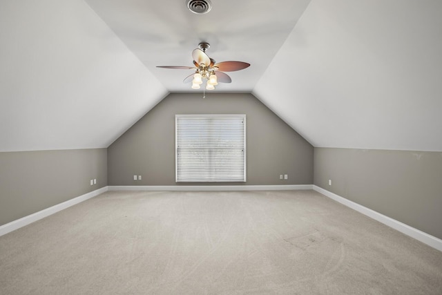 bonus room with lofted ceiling, light colored carpet, and ceiling fan