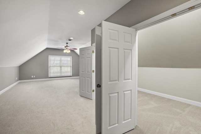 additional living space featuring lofted ceiling, light colored carpet, and ceiling fan