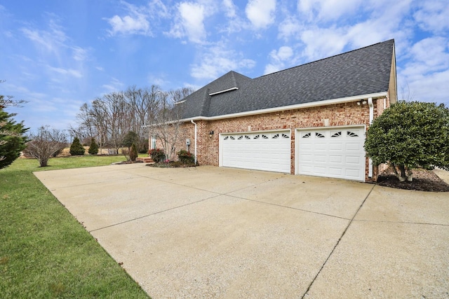 view of home's exterior with a garage and a lawn