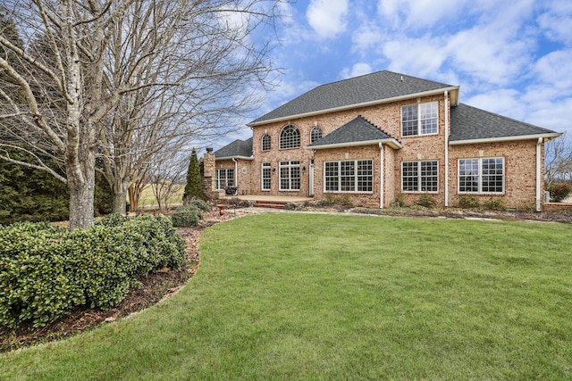 back of house featuring a yard