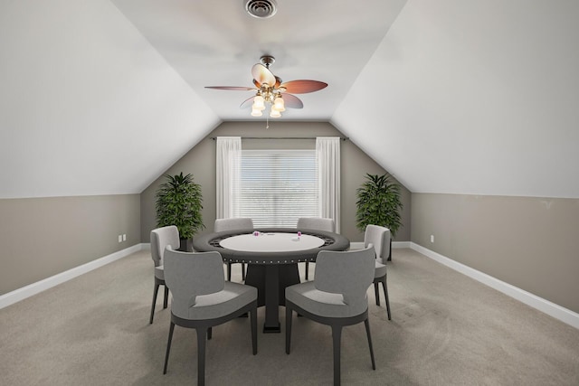 dining space with lofted ceiling, light colored carpet, and ceiling fan