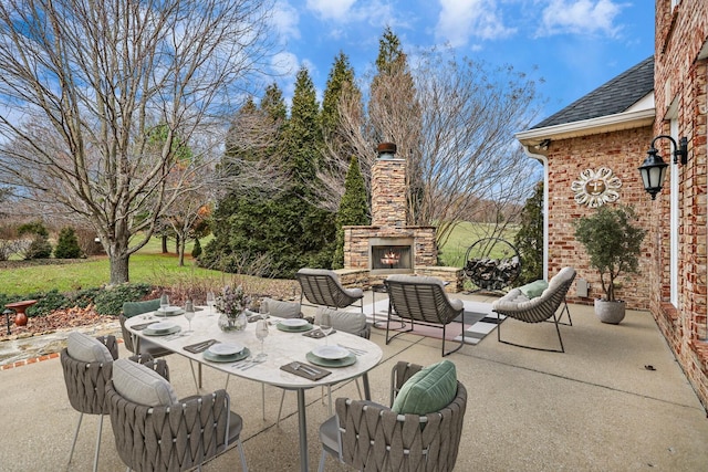 view of patio featuring an outdoor stone fireplace