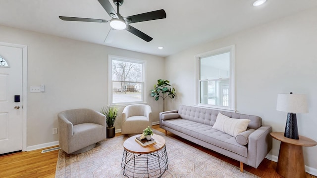 living room with ceiling fan and light wood-type flooring